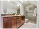 Modern bathroom with granite counters, wood cabinets and glass shower at 2224 N Humboldt St, Denver, CO 80205
