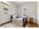Cozy bedroom featuring light walls, hardwood floors and door to the outside at 2224 N Humboldt St, Denver, CO 80205