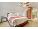 Bedroom featuring sloped ceiling, brick accent, and large bed at 2224 N Humboldt St, Denver, CO 80205