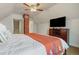 Bedroom featuring sloped ceiling, brick accent wall, and flat screen TV at 2224 N Humboldt St, Denver, CO 80205
