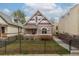 Charming home featuring unique architectural details and a well-maintained front yard with black metal fence at 2224 N Humboldt St, Denver, CO 80205