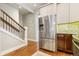 Bright kitchen with stainless steel refrigerator adjacent to staircase at 2224 N Humboldt St, Denver, CO 80205