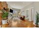Cozy living room with hardwood floors, modern fireplace, and a view into a connected bedroom at 2224 N Humboldt St, Denver, CO 80205