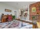 Open concept living room with exposed brick wall, wood floors, flows into bar kitchen space at 2224 N Humboldt St, Denver, CO 80205