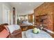 Warm living room with exposed brick wall, hardwood floors flowing into an open-concept kitchen at 2224 N Humboldt St, Denver, CO 80205