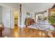 Open-concept living space with hardwood floors leading to a kitchen and bathroom at 2224 N Humboldt St, Denver, CO 80205