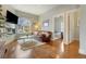 Bright living room features a fireplace, view through an arched window, and hardwood floors at 2224 N Humboldt St, Denver, CO 80205