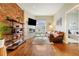 Inviting living room boasts a brick wall, fireplace, mounted TV, and stylish decor at 2224 N Humboldt St, Denver, CO 80205
