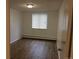 Bright bedroom features wood floors, and a window with blinds at 8826 E Florida Ave # 103, Denver, CO 80247