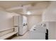 Clean, well-lit laundry room with multiple washers and dryers, plus a bench for convenience at 8826 E Florida Ave # 103, Denver, CO 80247