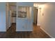 A pass-through from the living area reveals a well-lit kitchen with white cabinets at 8826 E Florida Ave # 103, Denver, CO 80247