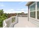 Home deck area with railings overlooking the neighborhood and trees at 5282 E 116Th Ave, Thornton, CO 80233