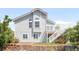 Two-story home with white siding, landscaping, and a small deck area at 5282 E 116Th Ave, Thornton, CO 80233