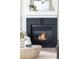Elegant fireplace with dark brick surround and mantel, creating a warm ambiance at 5282 E 116Th Ave, Thornton, CO 80233