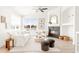 Inviting living room with large windows, fireplace, and comfortable white sofa at 5282 E 116Th Ave, Thornton, CO 80233
