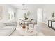 Open concept living and dining area featuring lots of natural light, wood floors, and modern furniture at 5282 E 116Th Ave, Thornton, CO 80233