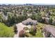 An aerial view of the estate, showcasing the circular driveway, lush landscaping, and surrounding trees at 6180 E Quincy Ave, Cherry Hills Village, CO 80111
