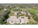 An aerial view of the estate, nestled amongst lush trees, and a view of surrounding properties at 6180 E Quincy Ave, Cherry Hills Village, CO 80111