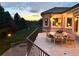 A sunset view from the balcony featuring mountain views and an outdoor dining table and seating at 6180 E Quincy Ave, Cherry Hills Village, CO 80111