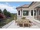 A sunlit view from the balcony featuring mountain views and an outdoor dining table and seating at 6180 E Quincy Ave, Cherry Hills Village, CO 80111