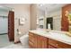 Bright bathroom featuring wood cabinets, a walk-in closet, a walk-in shower, and marble countertops at 6180 E Quincy Ave, Cherry Hills Village, CO 80111