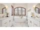 A luxurious bathroom with a soaking tub and dual vanities at 6180 E Quincy Ave, Cherry Hills Village, CO 80111