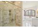 Modern bathroom featuring glass-enclosed shower with marble tile and convenient built-in storage shelves at 6180 E Quincy Ave, Cherry Hills Village, CO 80111