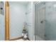 Bathroom with blue patterned wallpaper and a glass-enclosed shower at 6180 E Quincy Ave, Cherry Hills Village, CO 80111