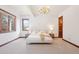 Bright, spacious bedroom featuring a cozy queen-sized bed and decorative, traditional wood trim at 6180 E Quincy Ave, Cherry Hills Village, CO 80111