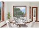 Dining area with nature views and a table set for an intimate gathering at 6180 E Quincy Ave, Cherry Hills Village, CO 80111