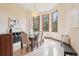 Bright dining room with a chandelier, large windows, and seating for six at 6180 E Quincy Ave, Cherry Hills Village, CO 80111