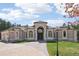 Stunning home with arched windows, portico, and tile roof situated on a large lot at 6180 E Quincy Ave, Cherry Hills Village, CO 80111