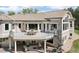 An elevated view of the back of the home, showcasing the outdoor patio and balcony seating areas at 6180 E Quincy Ave, Cherry Hills Village, CO 80111
