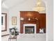 Cozy living room with a fireplace, decorative mantle, and stylish chandelier at 6180 E Quincy Ave, Cherry Hills Village, CO 80111