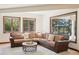 Inviting living room featuring comfortable sectional sofa and a view of the backyard gazebo at 6180 E Quincy Ave, Cherry Hills Village, CO 80111