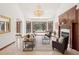 Elegant living room with large bay window, fireplace, and comfortable seating area at 6180 E Quincy Ave, Cherry Hills Village, CO 80111