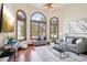 Bright living room featuring hardwood floors, abundant natural light, and stylish, contemporary furnishings at 6180 E Quincy Ave, Cherry Hills Village, CO 80111