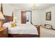 Spacious bedroom with a four-poster bed, white walls, a chandelier, and wood trim at 6180 E Quincy Ave, Cherry Hills Village, CO 80111