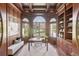 A beautiful office with wood paneled walls, coffered ceiling, and large picture windows at 6180 E Quincy Ave, Cherry Hills Village, CO 80111