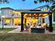 Covered patio featuring a fire pit, lounge chairs, and exterior spiral staircase to the home's second story at 6180 E Quincy Ave, Cherry Hills Village, CO 80111
