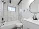 Modern bathroom with marble tile and updated fixtures at 4348 S Jason St, Englewood, CO 80110