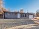 Ranch style home with gray exterior, landscaped yard, and attached garage at 4348 S Jason St, Englewood, CO 80110