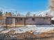 House exterior with covered patio and snowy yard at 4348 S Jason St, Englewood, CO 80110