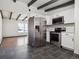 Updated kitchen featuring stainless steel appliances and dark tile floors at 4348 S Jason St, Englewood, CO 80110