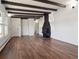 Living room with hardwood floors, fireplace, and exposed beam ceiling at 4348 S Jason St, Englewood, CO 80110