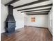 Living room showcasing hardwood floors and a vintage fireplace at 4348 S Jason St, Englewood, CO 80110