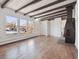 Bright living room featuring hardwood floors, exposed beams, and a fireplace at 4348 S Jason St, Englewood, CO 80110