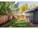 Private backyard with lush green lawn and wood fence, perfect for outdoor enjoyment at 1641 S Corona St, Denver, CO 80210