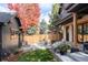 Serene backyard patio with a fire pit and comfortable seating, surrounded by vibrant fall foliage at 1641 S Corona St, Denver, CO 80210