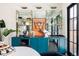 Stylish bar area with open shelving, a mirrored backsplash, marble countertops, and custom blue cabinets at 1641 S Corona St, Denver, CO 80210